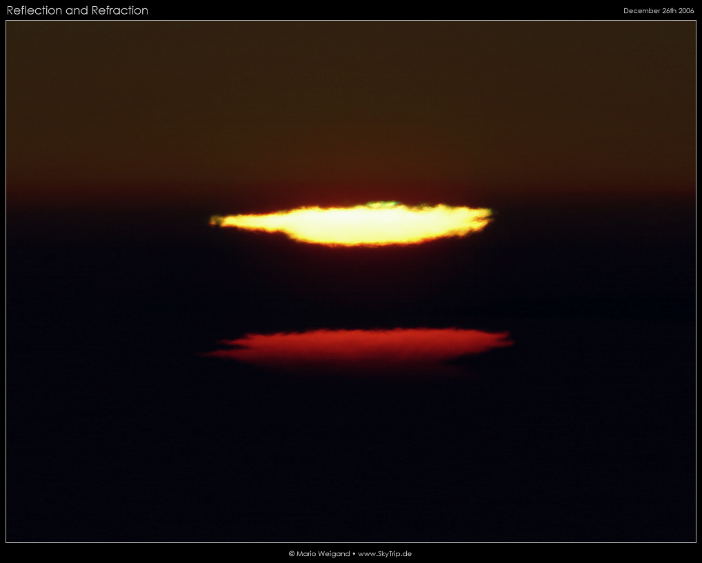 Grner Blitz und verzerrte Sonnenscheibe bei Sonnenuntergang